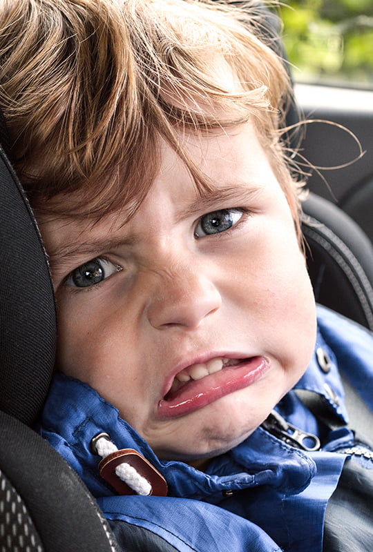 Schlecht gelauntes Kind im Auto-Kindersitz